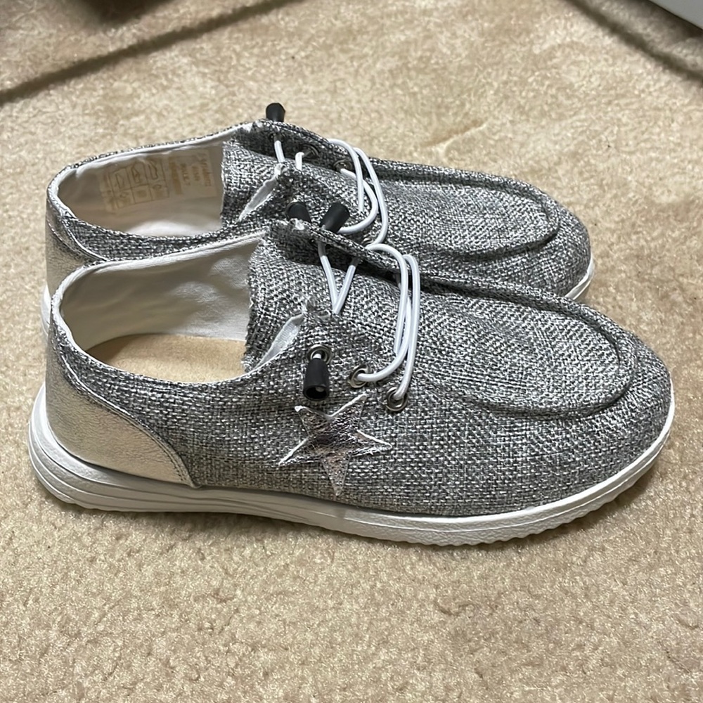 Gray slip on shoes never worn, size 6.5, bought from a boutique but never wore.